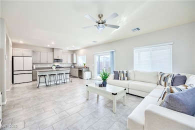 Living area featuring recessed lighting, ceiling fan, and light tile patterned flooring