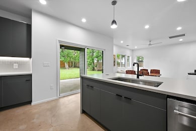 Kitchen with a sink, finished concrete flooring, 