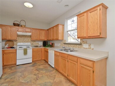 Large kitchen with stone backsplash and beautiful large scale tile.