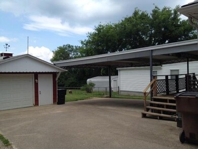 Concrete driveway and covered 2 car carport. Plenty of parking