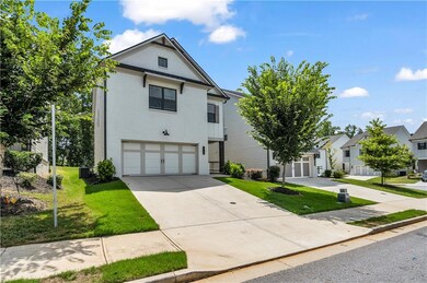 Traditional-style home with brick siding, driveway, an attached garage, and a front yard