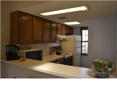 Kitchen fully applianced with an eating bar.