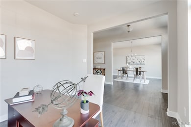 Dining room with a notable chandelier, baseboards,