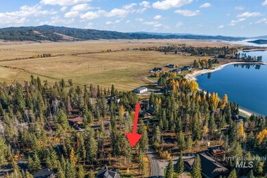 Aerial view of property and surrounding area featuring a water and mountain view