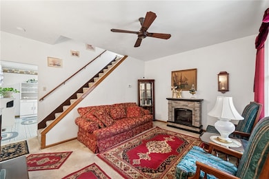 Open Central Stairs and Stone Face Fireplace featu
