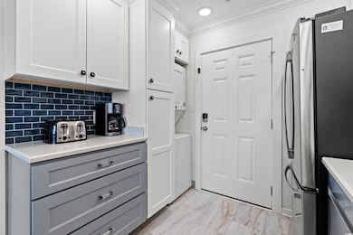 Kitchen with marble finish floor, gray cabinets, c