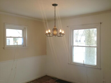 Dining Room with Updated windows view side and Backyard. Open to both Living Room and Kitchen. Chairrail and Hardwood floors beneath carpeting are in process of being refinished!