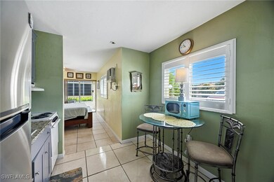 Kitchen featuring freestanding refrigerator, white