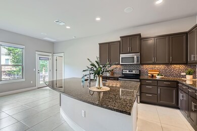 Kitchen with stainless steel appliances, dark bro