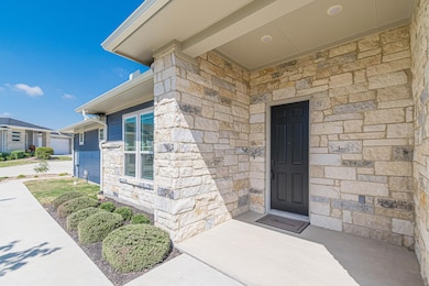 Doorway to property with stone siding