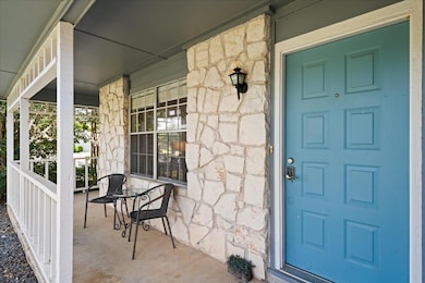 Property entrance featuring stone siding and cove