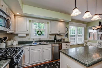 5 burner gas cooktop stove and white tile backsplash are in demand.