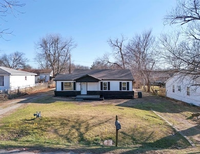 View of front of house with a front yard and fence