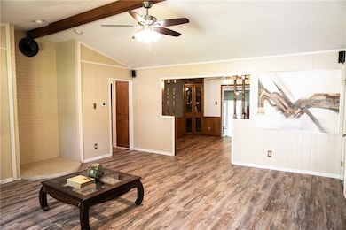 Unfurnished living room with lofted ceiling with b