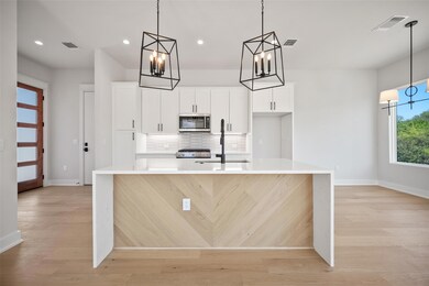Kitchen featuring a chandelier, stainless steel m