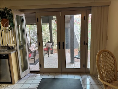 Entryway featuring french doors and light tile patterned flooring