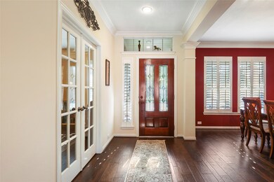 Step inside to find beautiful hand-scraped engineered hardwood floors, decorator paint, and incredible natural light.  There is a spacious study through the gorgeous French doors and the elegant formal dining room is to the right in this photo.