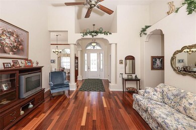 beautiful hardwood floors, columns and plant shelv