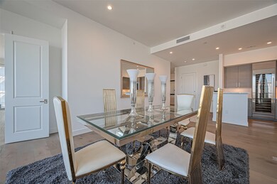 Modern dining area with a sleek glass table and st