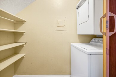 Washroom with stacked washer / drying machine