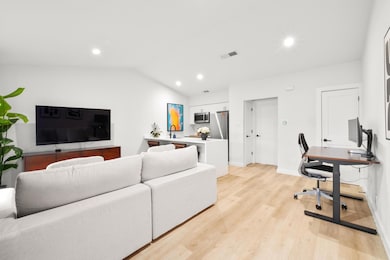 Living area with light wood-style flooring, an of
