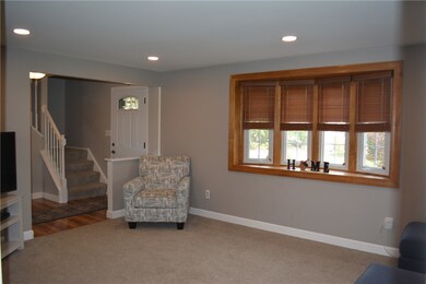 Living room with recessed lighting, bay window and