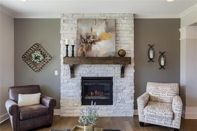 Floor-to-ceiling stone fireplace with rustic mante