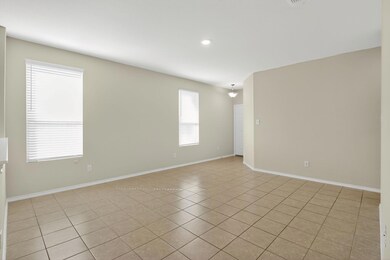 Empty room featuring light tile patterned floors and recessed lighting