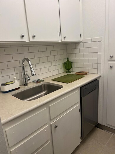 Kitchen with dishwashing machine, a sink, white c