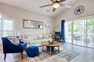 Living area with wood finished floors, a ceiling fan, and high vaulted ceiling