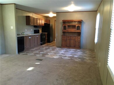 Kitchen with black appliances, light countertops,