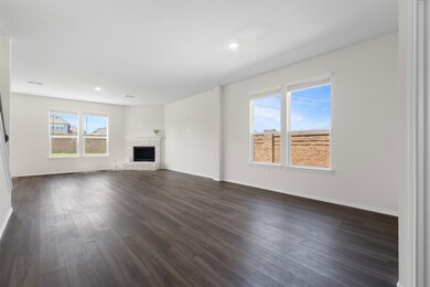 Unfurnished living room with plenty of natural light, dark wood-type flooring, and recessed lighting