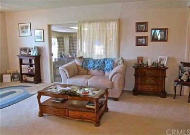 The living room opens to a spacious permitted sunr