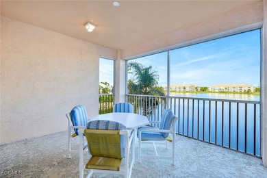 Sunroom with a textured wall and a water view