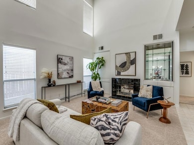 Carpeted living room featuring a see through firep
