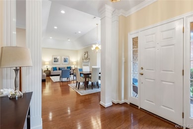 Columns,  wood floors make an elegant entrance.