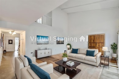 Living Room property  staged with double high ceilings.