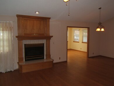 Gas fireplace in living room with adjoining dinnin