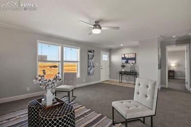 Living room with ornamental molding, ceiling fan, 