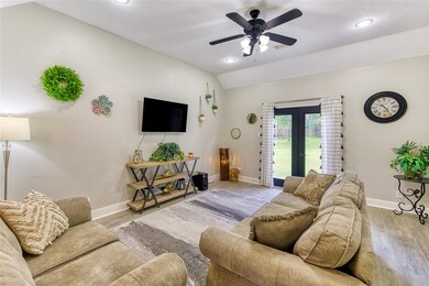 Family Room with double doors out to the patio and back door open to the Kitchen too.