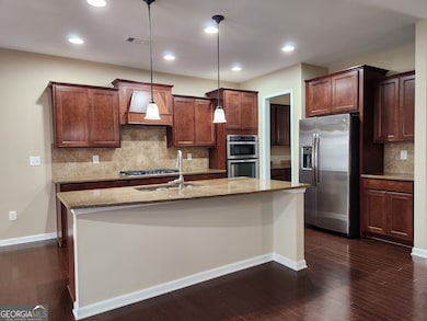 Rich stained cabinets, granite, vent hood, and SS 