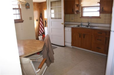 ANOTHER VIEW OF KITCHEN WITH OPEN DOOR TO MUD ROOM