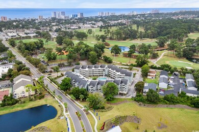 Aerial view of property and surrounding area with a nearby body of water