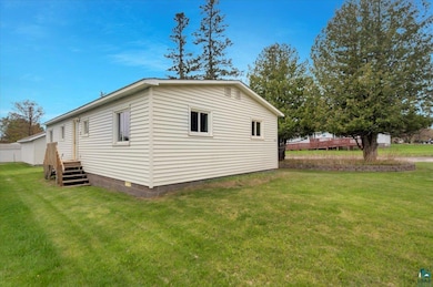 View of property exterior featuring a lawn