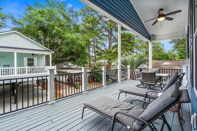 Wooden terrace with outdoor dining area and a ceiling fan