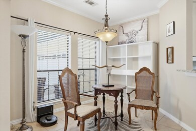 Dining room featuring light tile patterned floors and ornamental molding