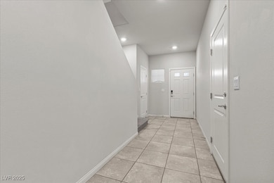 Entryway with tile patterned flooring and recessed lighting
