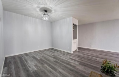 Spare room featuring dark wood finished floors, a