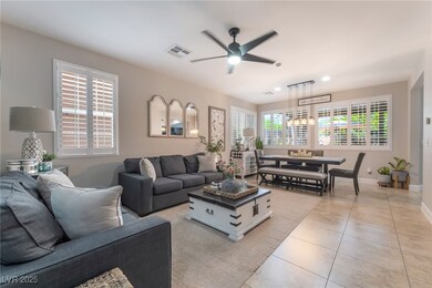 Living room with a ceiling fan, light tile pattern