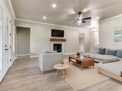 Living room featuring ceiling fan, light hardwood 